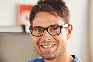 A smiling man wearing glasses.